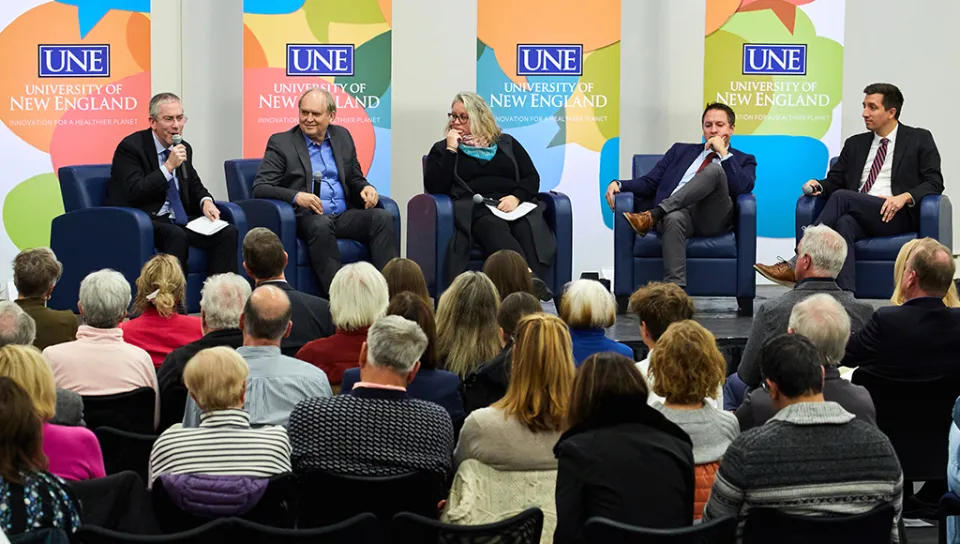 Bryan Caplan addressing a question while Robin Hanson, Shannon Zlotkowski, Hyrum Lewis, Verlan Lewis, and the crowd listen in.