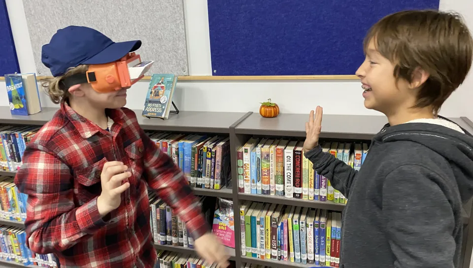 Two boys high-five each other at Maine Bioscience Day