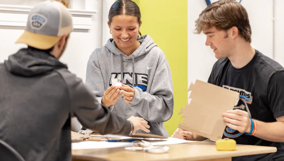 Students smile as they work together in the Makerspace