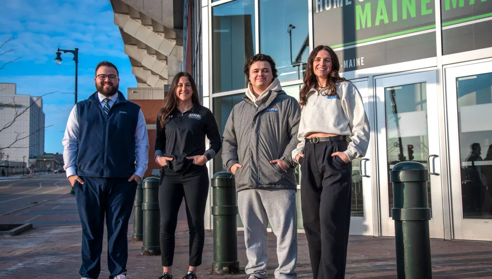 UNE students pose in front of the Cross Insurance Arena in Portland