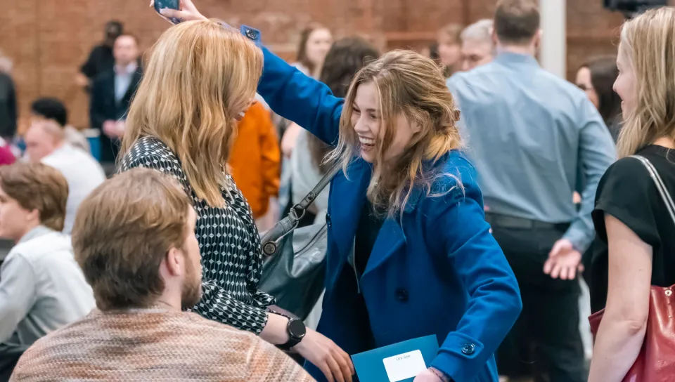 A medical student hugs her family members