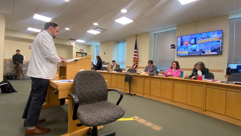A UNE medical student delivers testimony at the podium