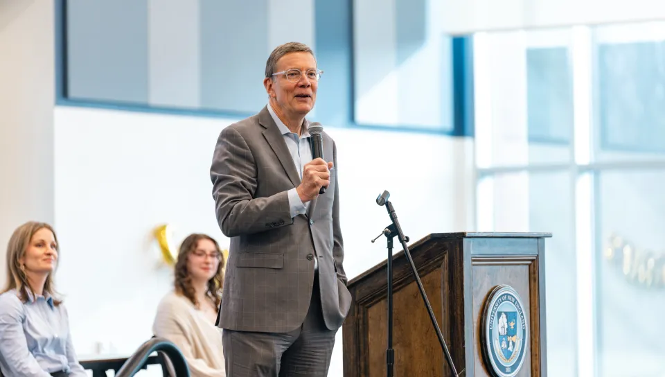 UNE President James Herbert speaks at the podium