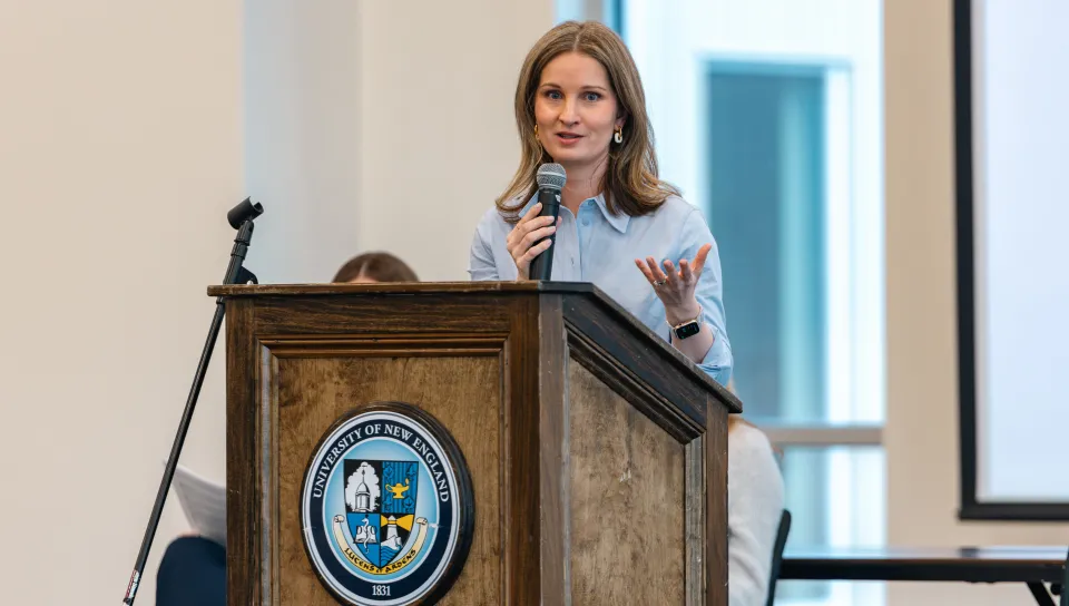 UNE's Jennifer Stiegler-Balfour speaks at the podium