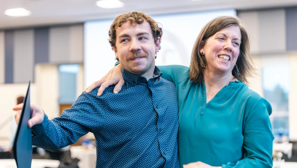 A UNE student and parent celebrate PSI CHI induction