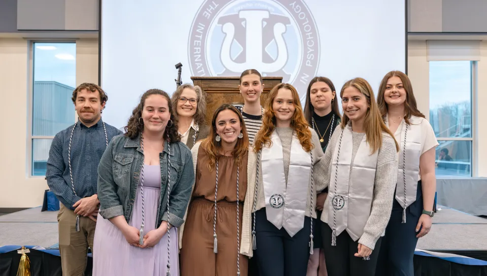 PSI CHI graduating seniors pose with their graduation cords and stoles