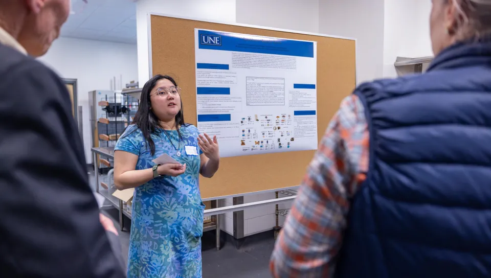A UNE student gives a business presentation