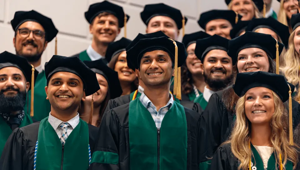 College of Osteopathic Medicine graduates pose for a photo inside Merrill Auditorium in Portland