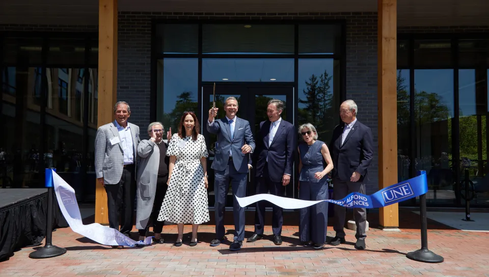 UNE administrators and trustees cut the ribbon for the Harold and Bibby Alfond Center for Health Sciences