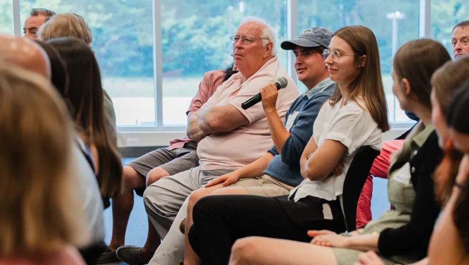 A student asks a question from the crowd