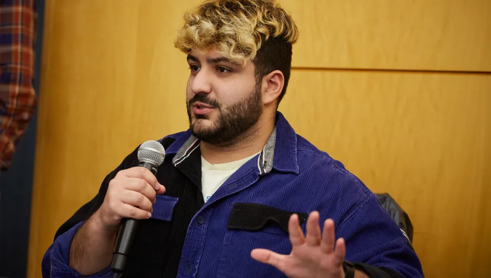 A student speaks into a microphone