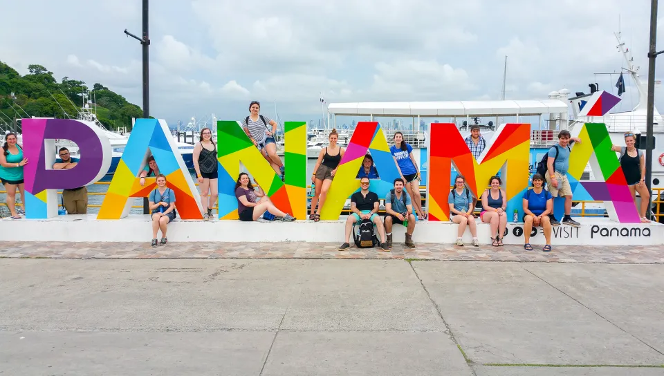Several students posing amongst large letters that spell, "Panama"