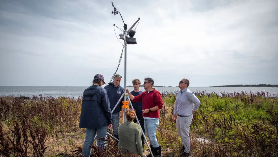 A UNE research team sets up weather sensors on Ram Island