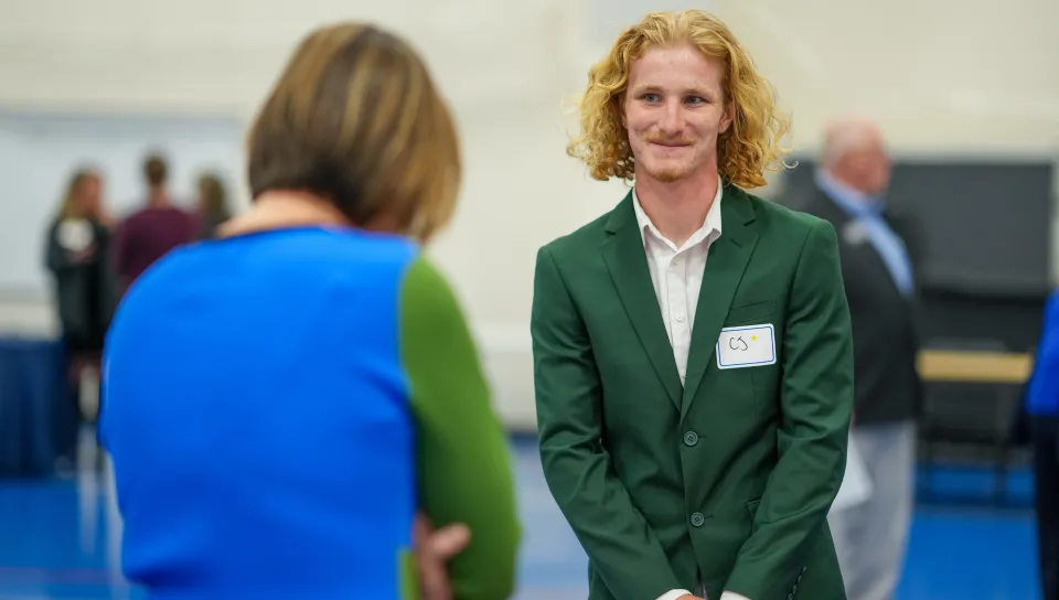 A UNE student speaks with a potential employer