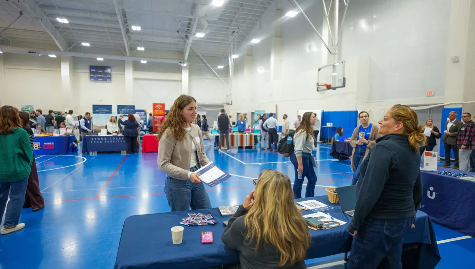 A UNE student meets with career services staff