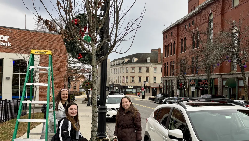 Since 2017, the University of New England students have volunteered to help the Heart of Biddeford non-profit decorate downtown Biddeford with holiday lights. This year, the light brigade showed up in force on Nov. 16 as 28 students climbed ladders up and down Main Street to help hang lights and decorate the town for the holidays.