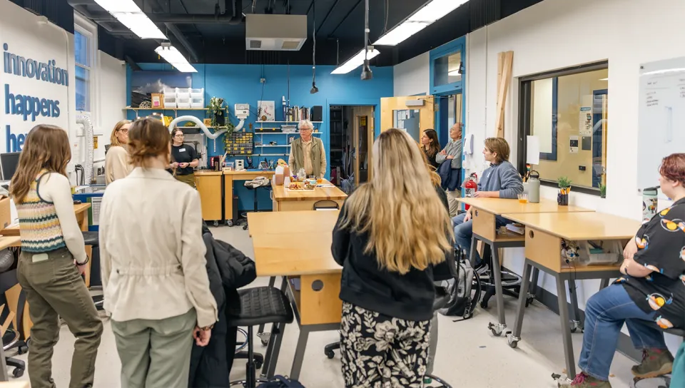 Students and faculty gather in the UNE Center for Innovation and Entrepreneurship makerspace during a Shaw Fellowship meeting, with "innovation happens here" visible on the wall