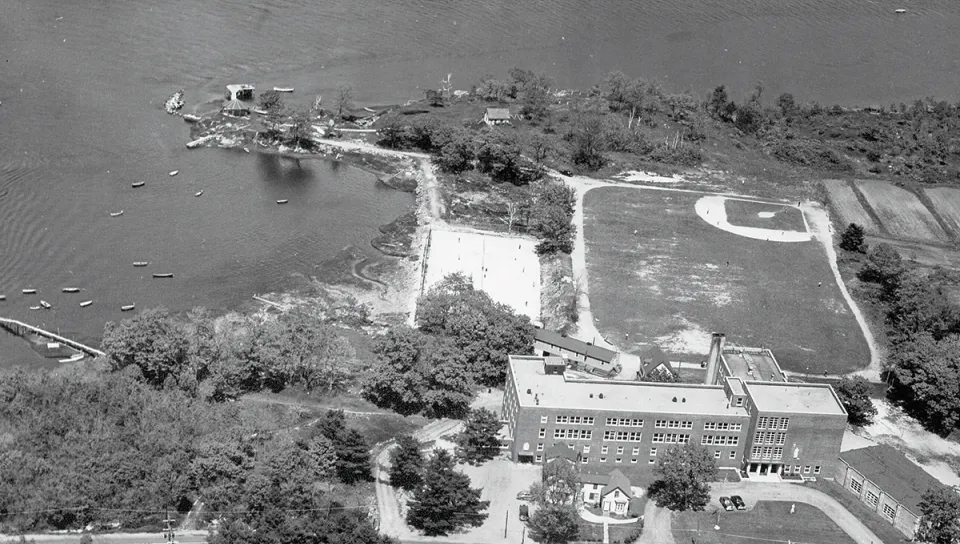Historical black-and-white aerial photograph from 1954 showing The Wayside building on UNE's Biddeford Campus before it was razed in 1963.