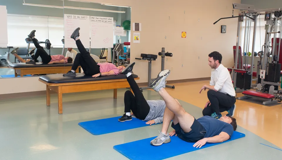 Patients perform therapeutic exercises under the guidance of healthcare professionals in the functional restoration program gym at Dartmouth Hitchcock Medical Center.