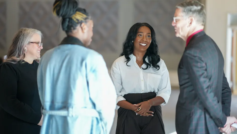 Melissa Hue speaking with President Hubert