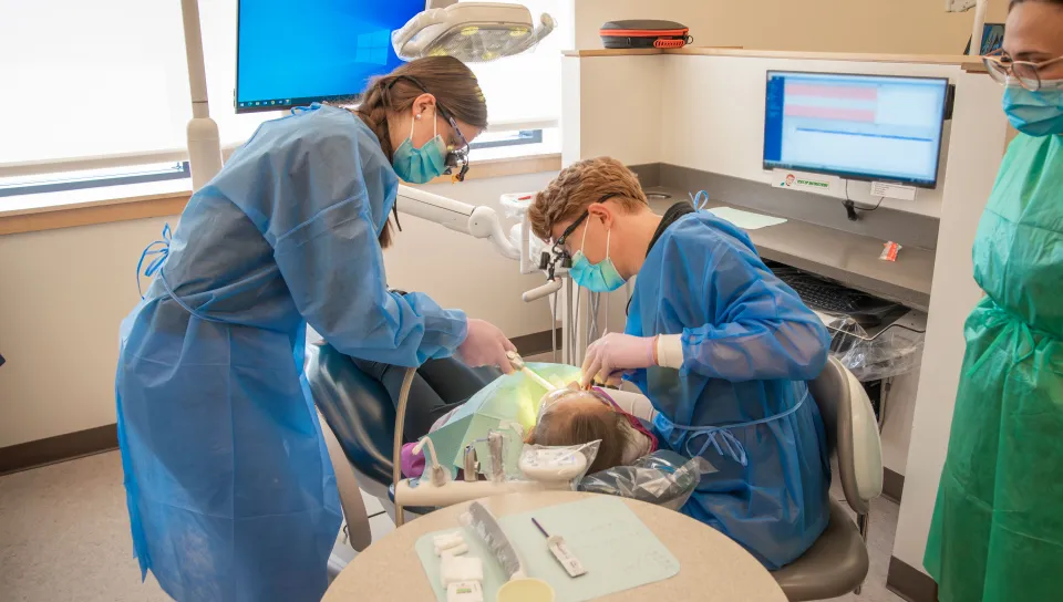 UNE dentistry and dental hygiene students provide oral health care for a pediatric patient