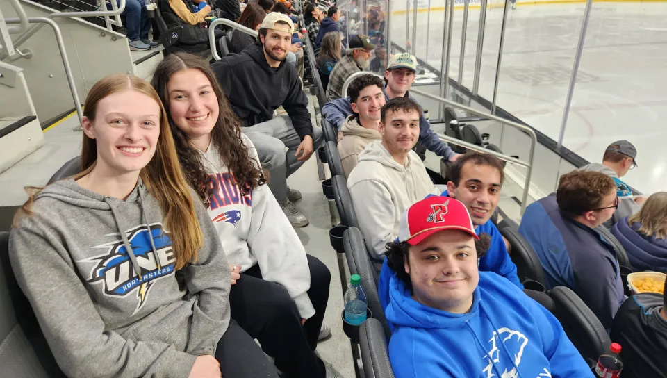 Students sit in the stands at a San Jose Sharks game