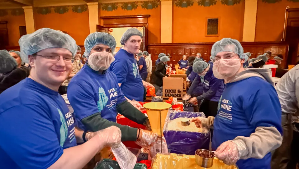 Since starting in 2023, UNE’s large-scale, meal-packaging effort had produced 300,000 meals for individuals and families throughout the state; Wednesday’s event brought that number to 350,000. The Masonic foundation joined the effort last fall to help the program reach all 16 counties in Maine for the first time.  UNE Service Learning Director Trisha Mason said in her opening remarks that the Meals for Maine partnership with the Masons typifies UNE’s experiential-learning approach to education by providing 