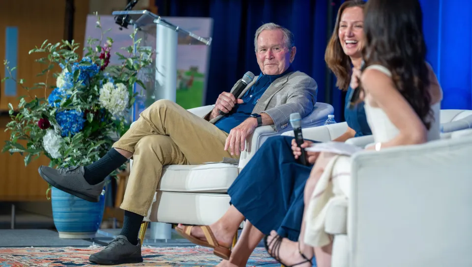 George W. Bush speaks in a panel onstage