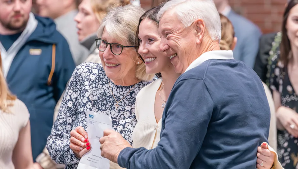 A U N E College of Osteopathic Medicine student laughs with her grandparents while celebrating Match Day.