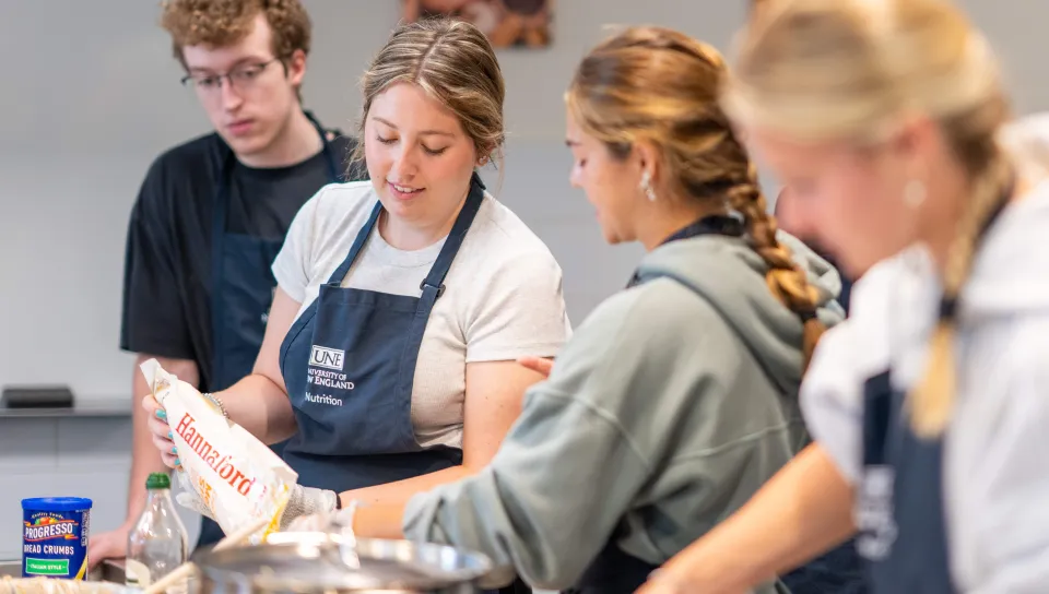 Students cook together in UNE's Teaching Kitchen