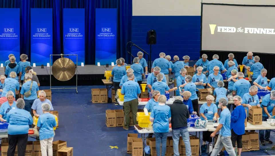 UNE, community volunteers pack a record 200,000 meal kits to combat hunger across Maine