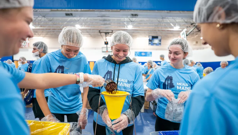 UNE, community volunteers pack a record 200,000 meal kits to combat hunger across Maine