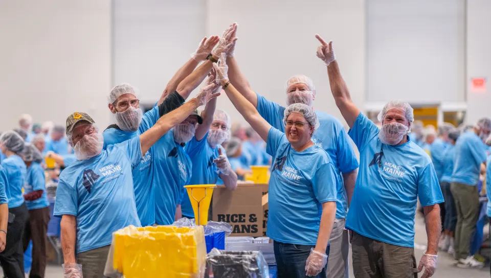 UNE, community volunteers pack a record 200,000 meal kits to combat hunger across Maine