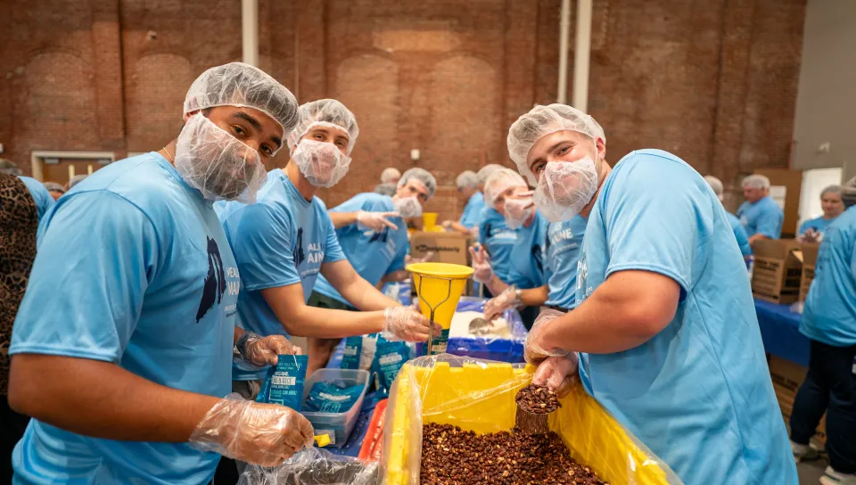 UNE, community volunteers pack a record 200,000 meal kits to combat hunger across Maine