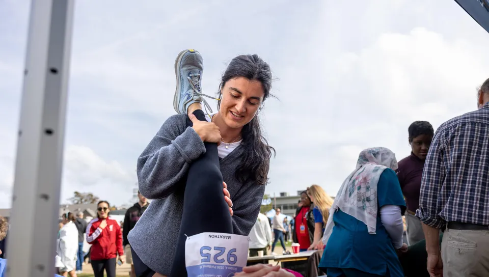 A UNE medical student treats a runner after the Maine Marathon