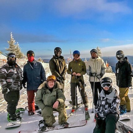 A group of graduate students posing before skiing and snowboarding