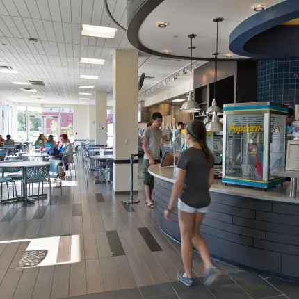 A student walks up to the bar in the Alfond Cafe