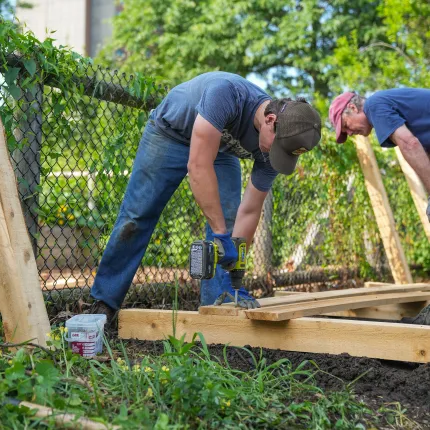 Luke Jenkins (Biology, ’26) and Cameron Wake, Ph.D. building a wooden garden bed