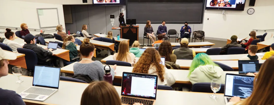 View of students sitting in the lecture hall with laptops open at the climate teach-in