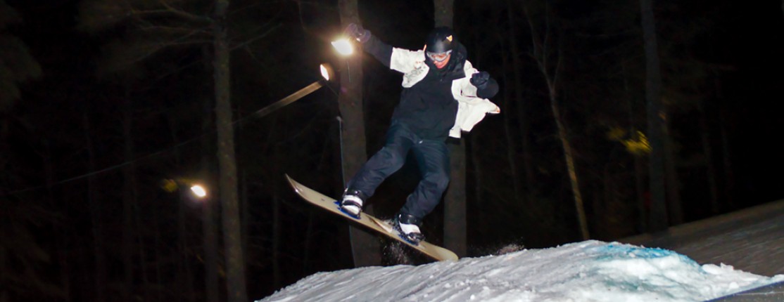 A student catches air while skiing