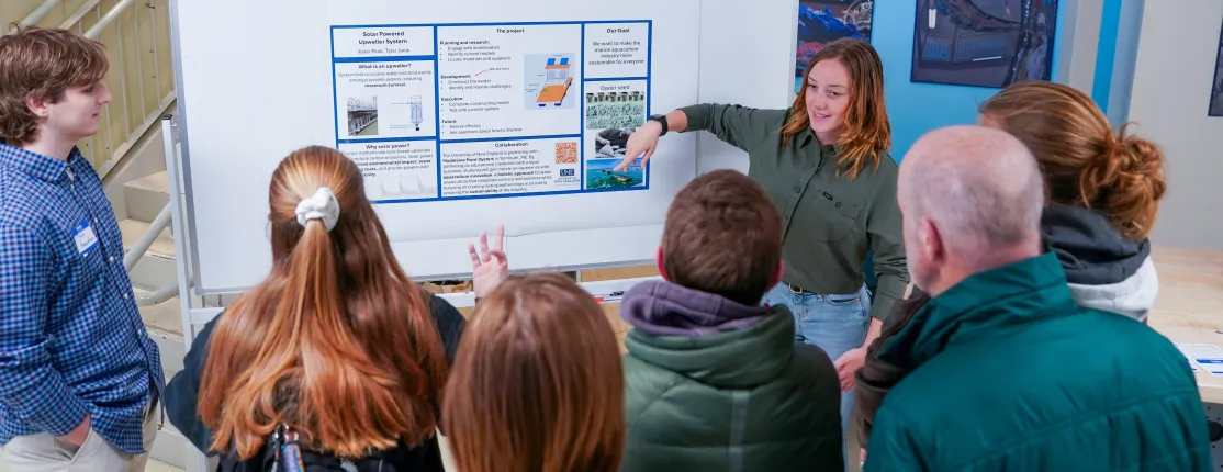 Janik and partner Kalei Peck deliver a poster presentation