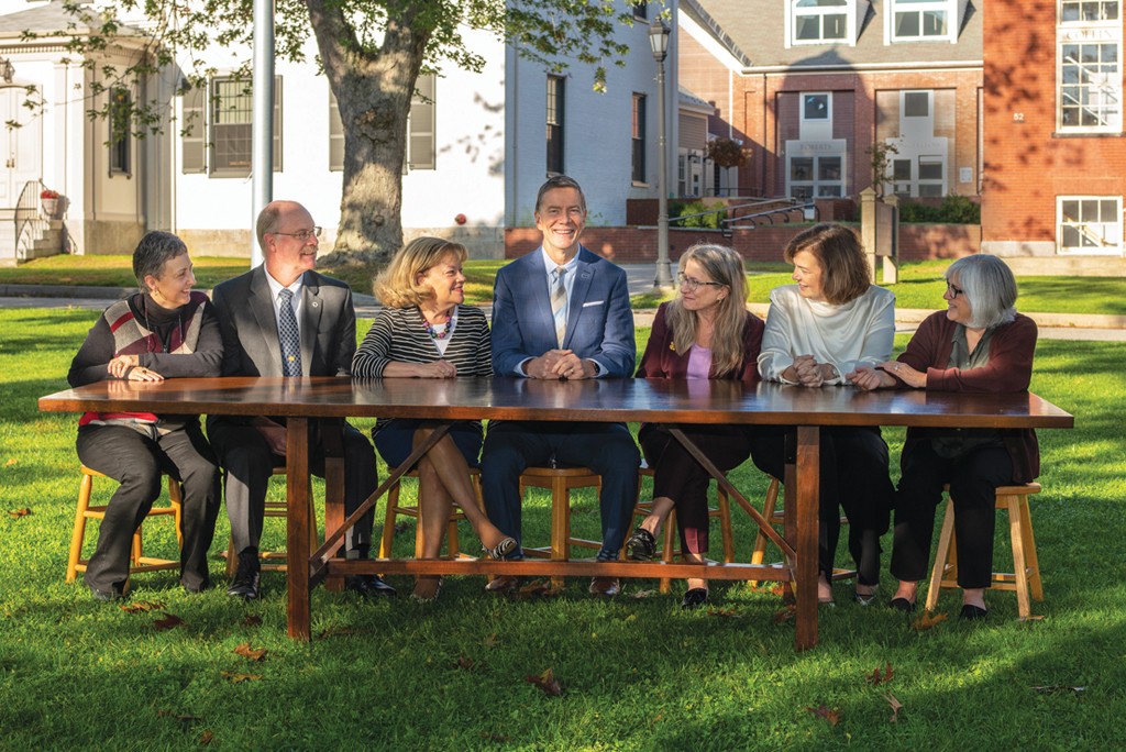 President Hebert sitting with several U N E faculty and staff members
