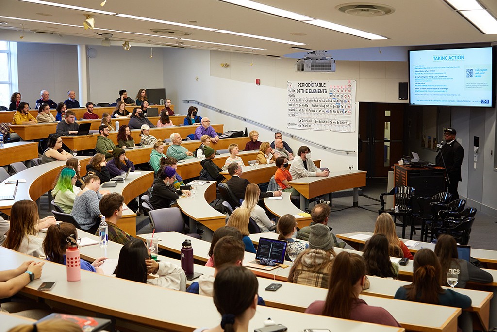 Students in a lecture hall listening to a speaker at a Climate Teach-In event