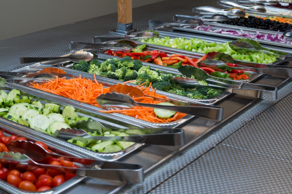 Peppers, cucumbers, carrots and other vegetables in the salad bar 