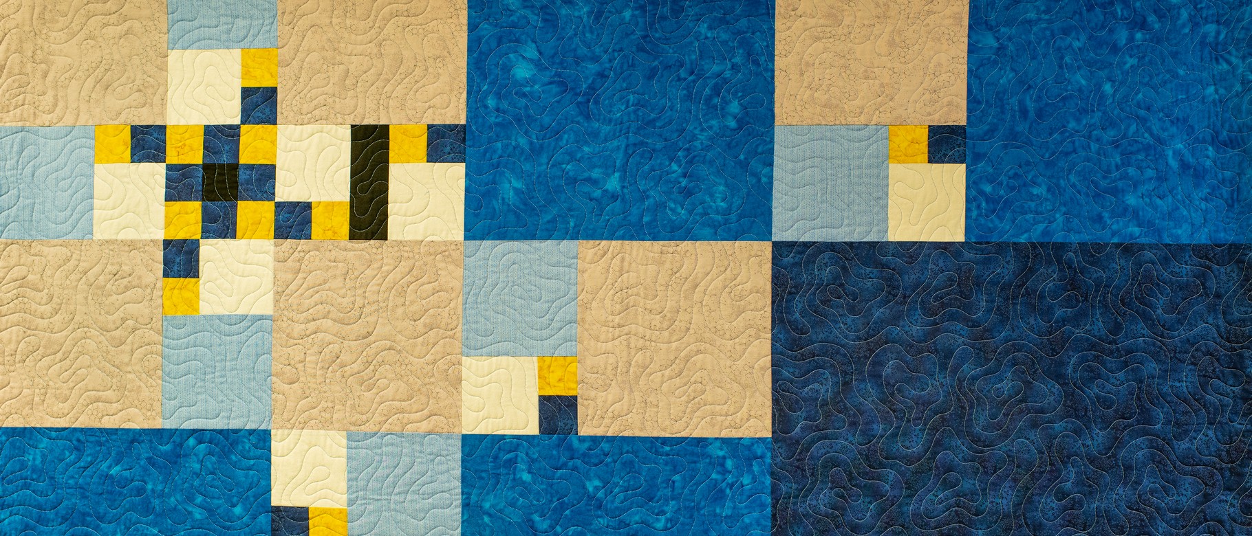 A quilt designed by Ryan Hedstrom, M.S.T., associate teaching professor in the School of Mathematical and Physical Sciences, showcases a design based on the Fibonacci sequence.