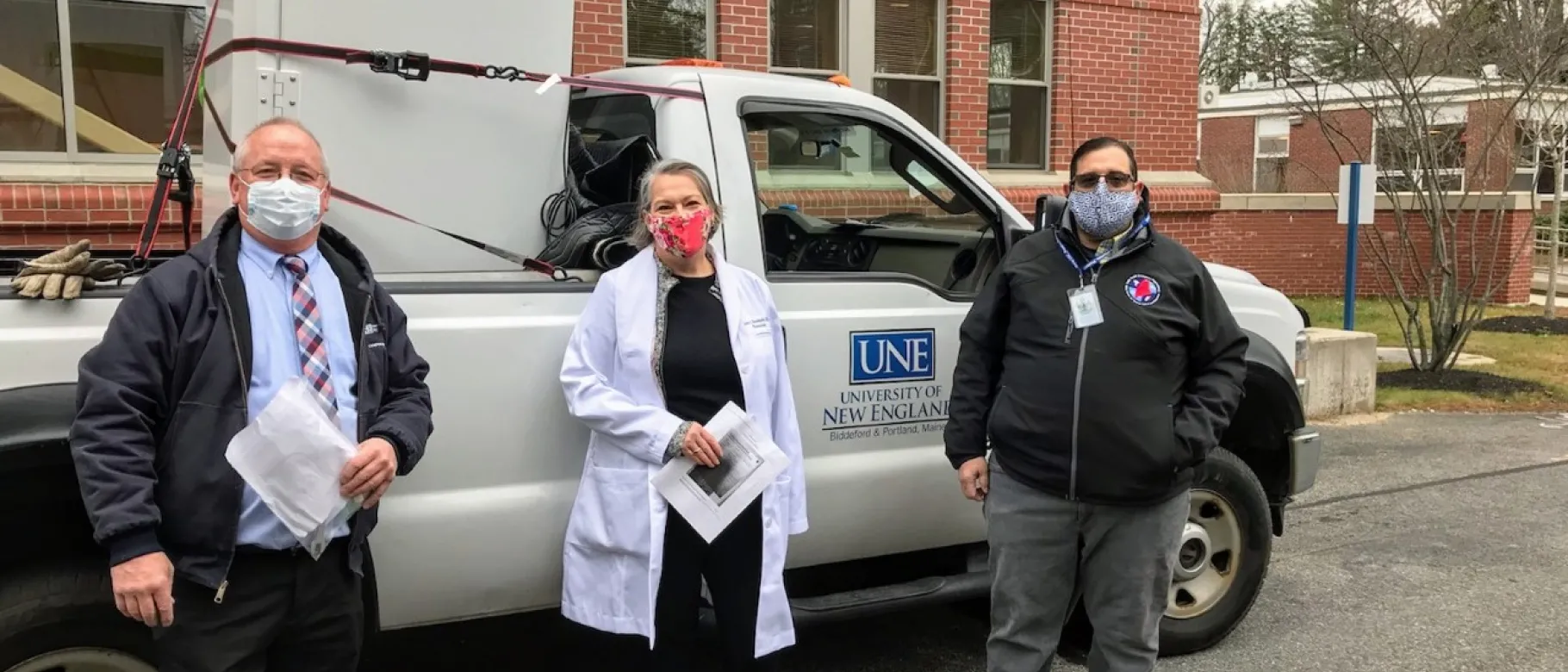 John Reid, left, facilities manager at the University of New England, stands with Karen Houseknecht, UNE’s associate provost for research, and Steven Boucouvalis, emergency operations coordinator with the Maine Center for Disease Control and Prevention. The ultra-cold freezer was delivered to a Maine CDC facility in a location that’s being kept secret for security reasons