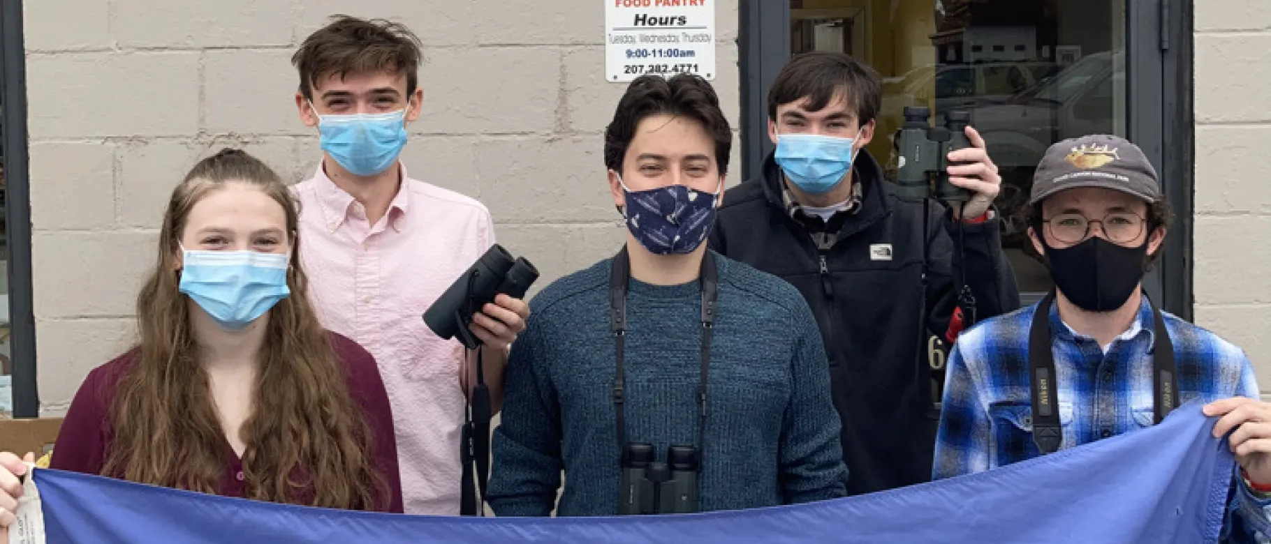 UNE Birding Club poses in front of Biddeford Food Pantry