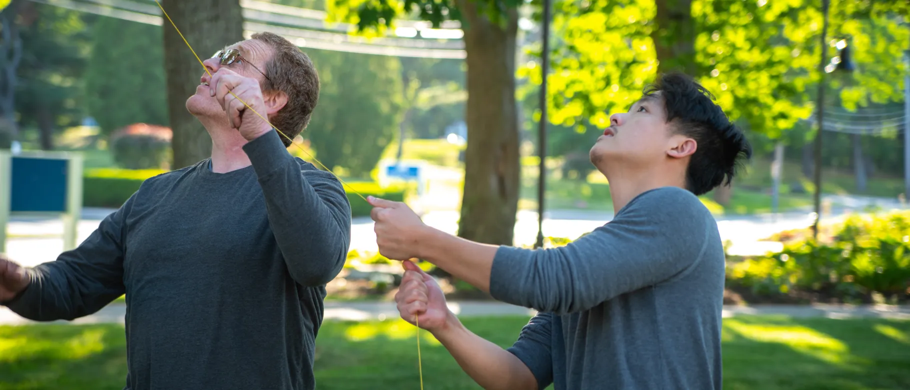 Students adjust a lead line for climbing a tree