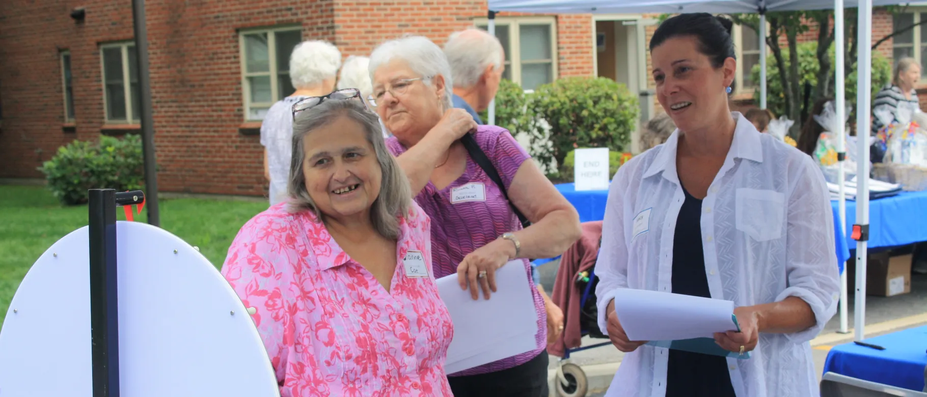 Two women stand at festival booth