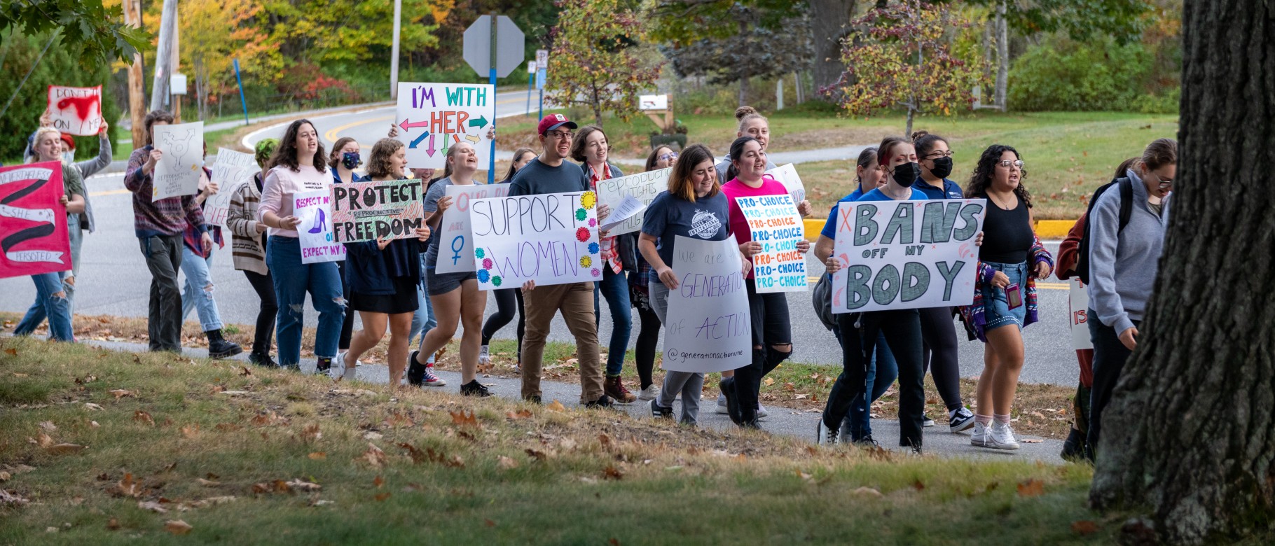 A group of students march through campus
